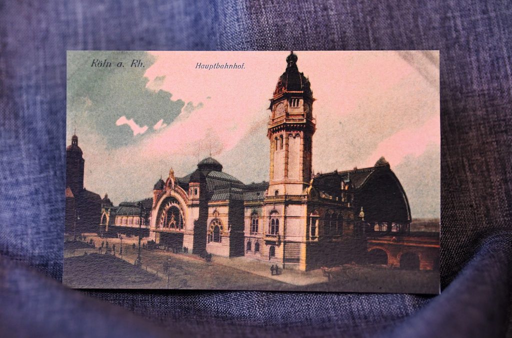 ABOVE: This undated postcard shows a colored drawing of the train station in Cologne, Germany.